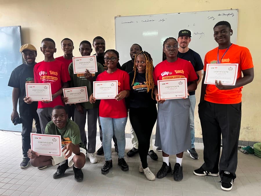 Students holding their graduation certificates at the Summit